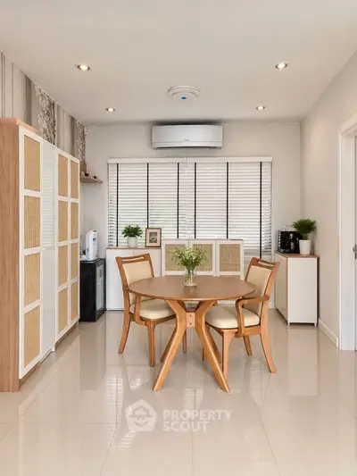 Modern dining area with stylish wooden furniture and air conditioning, perfect for cozy meals.