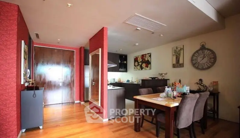 Stylish open-plan living and dining area with modern kitchen in a cozy apartment.