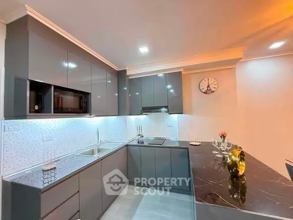 Modern kitchen with sleek gray cabinets and elegant marble countertop