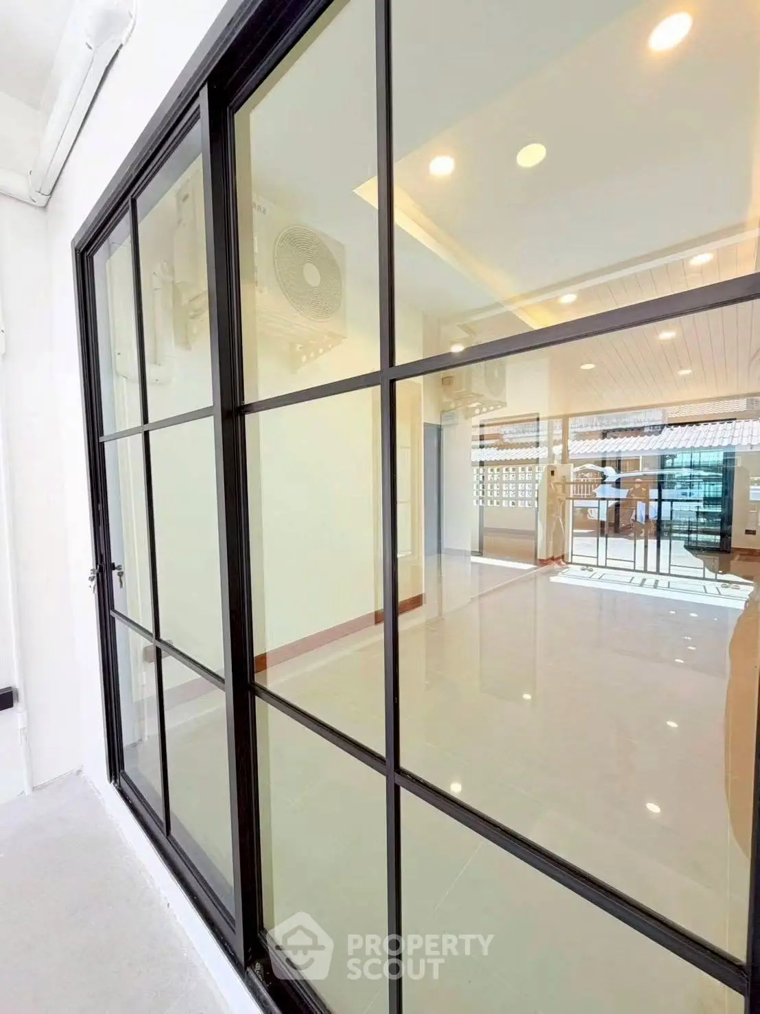 Spacious modern living room with large windows and sleek design, perfect for natural light and open living.