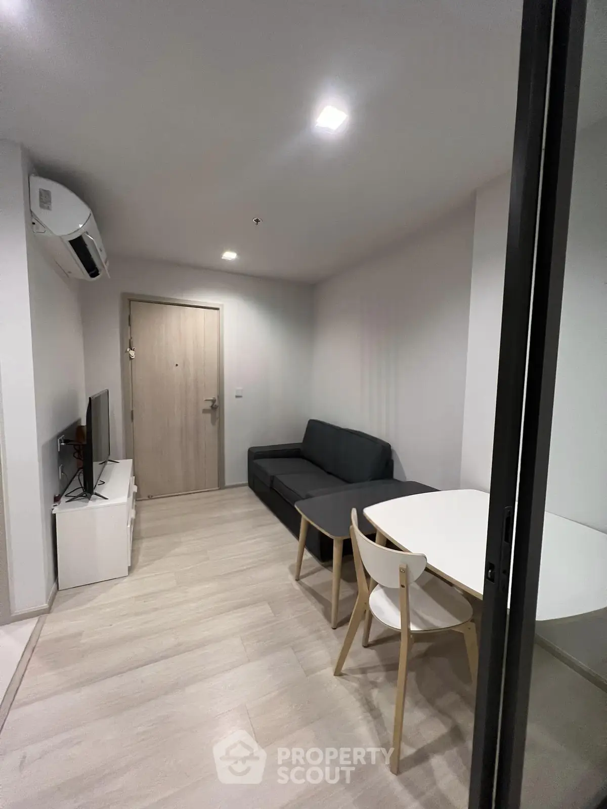 Modern living room with sleek furniture and minimalist design in a cozy apartment.