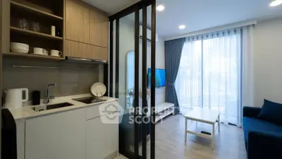 Modern open-layout kitchen and living room with sleek design and natural light