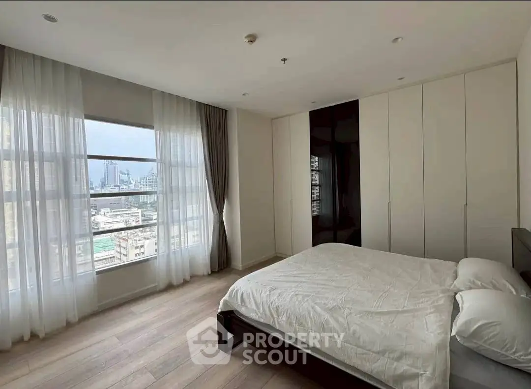 Spacious bedroom with city view and ample natural light