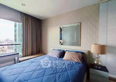 Modern bedroom with city view, featuring a cozy bed and stylish decor.