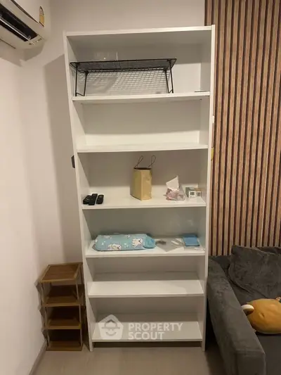 Modern living room with white shelving unit and cozy sofa