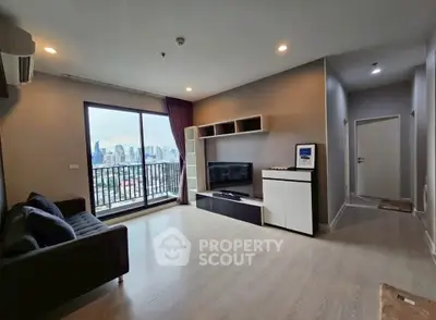 Modern living room with city view, stylish furniture, and large window in a high-rise apartment.