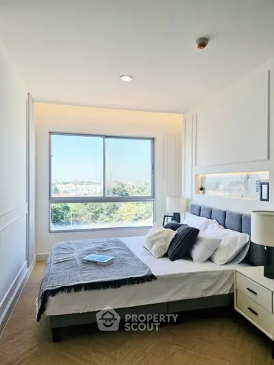 Bright and modern bedroom with large window and stylish decor