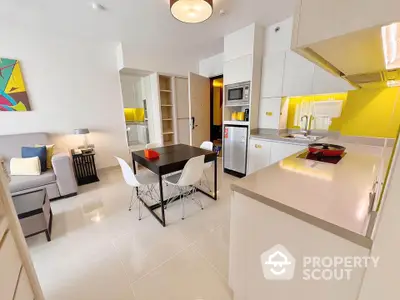 Modern open-layout kitchen and dining area with sleek design and bright accents