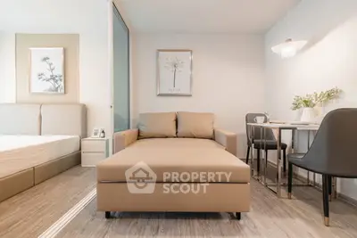 Modern studio apartment with stylish decor and cozy seating area, perfect for urban living.