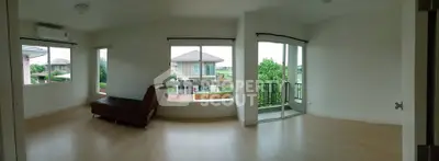 Spacious living room with large windows and balcony offering scenic views in modern home.