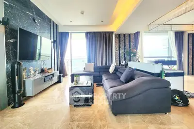 Luxurious living room with marble floors, modern decor, and large windows offering stunning views.