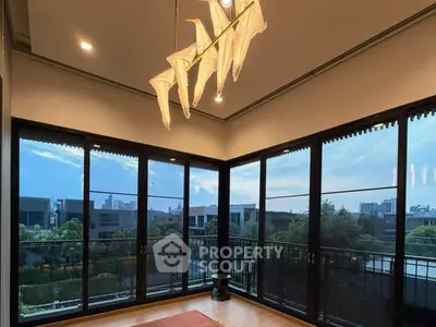 Luxurious corner unit with floor-to-ceiling windows offering stunning city views and elegant lighting.