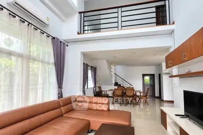 Spacious modern living room with high ceilings and elegant furniture in a stylish duplex apartment.