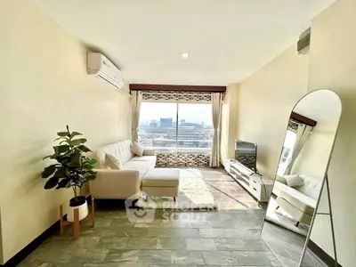 Bright living room with city view, modern furniture, and large mirror