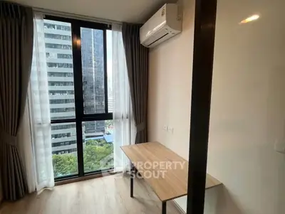 Modern study room with large window and city view in high-rise apartment