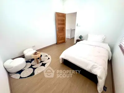 Cozy minimalist bedroom with wooden flooring and modern decor