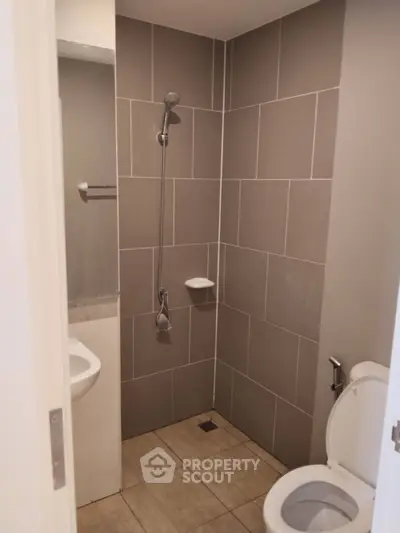 Modern bathroom with sleek gray tiles and compact design