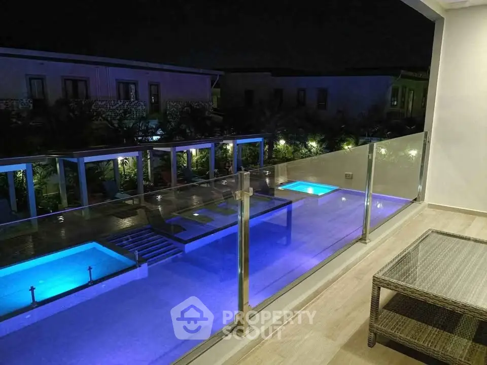 Luxurious night view of illuminated pool from modern balcony