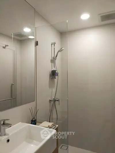 Modern bathroom with glass shower and sleek fixtures