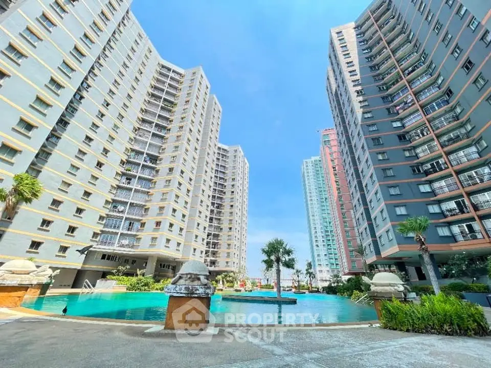 Stunning view of modern high-rise apartment buildings with a luxurious pool area.