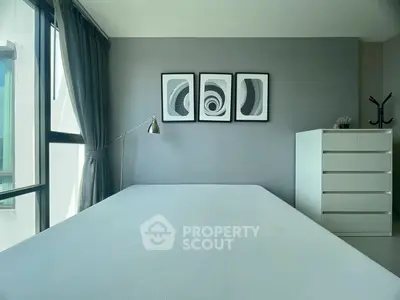 Modern minimalist bedroom with large window and stylish decor