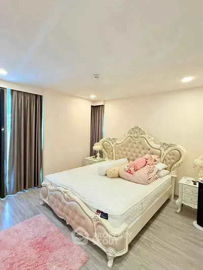 Luxurious bedroom with elegant decor and plush furnishings in a modern apartment.