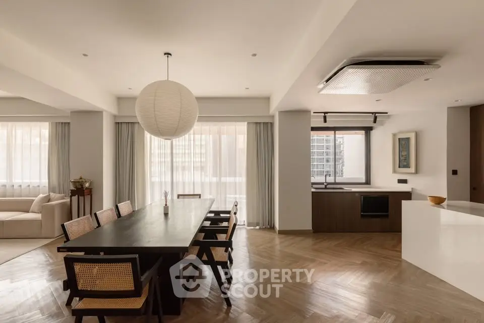 Spacious modern dining area with elegant wooden flooring and stylish furniture, perfect for entertaining guests.