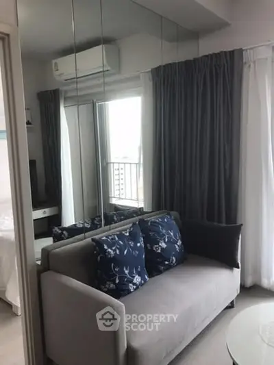 Modern living room with mirrored wall and cozy sofa in a stylish apartment