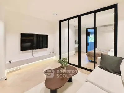 Modern living room with glass partition and sleek furniture design