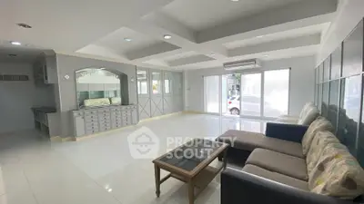 Spacious living room with modern furniture and large windows for natural light.