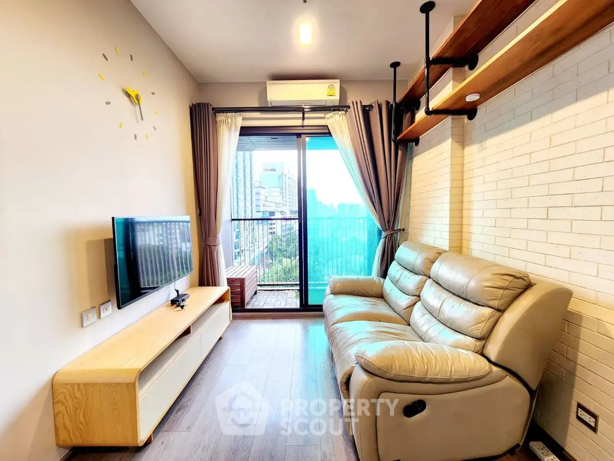 Modern living room with leather sofa and city view balcony in high-rise apartment.