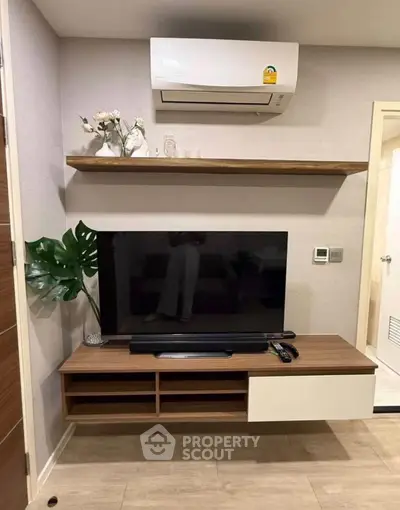 Modern living room with sleek TV unit and air conditioning, perfect for cozy entertainment.
