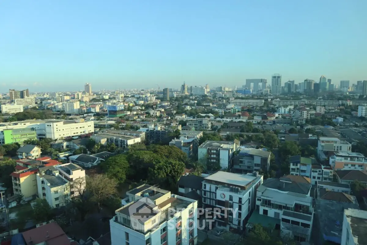 Stunning cityscape view showcasing urban skyline and residential buildings under clear blue sky.