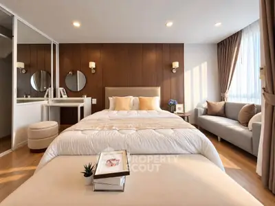 Luxurious bedroom with elegant decor and cozy seating area, perfect for relaxation and comfort.