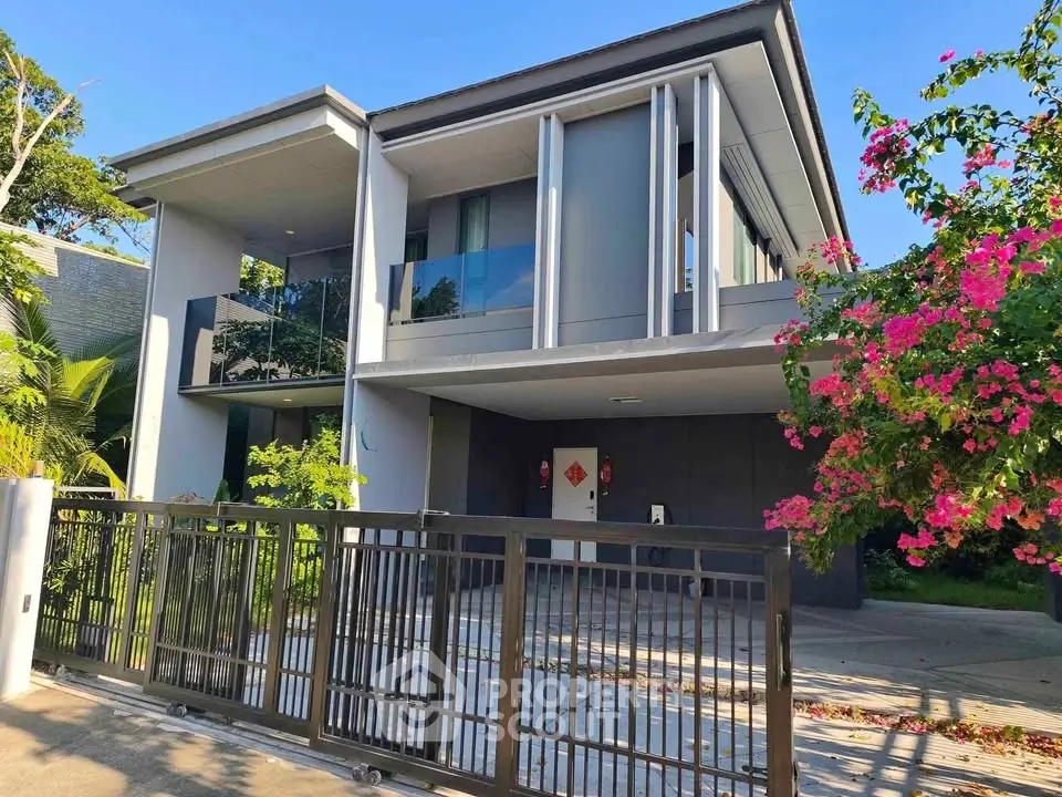 Modern two-story house with sleek design and lush garden in a serene neighborhood.