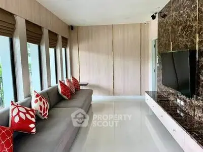 Spacious living room with modern decor and large windows