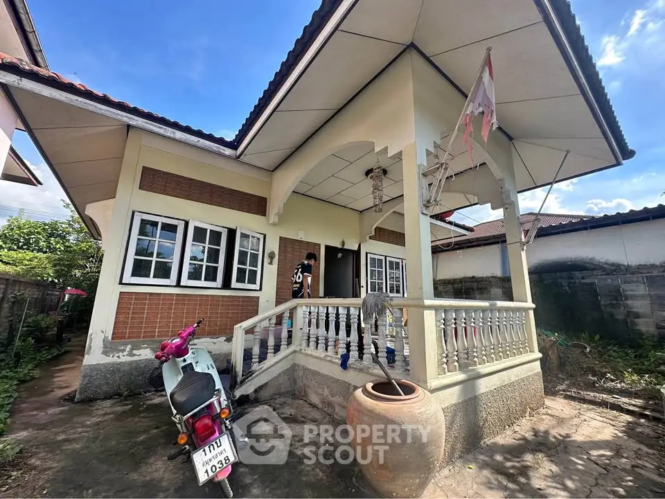 Charming single-story house with covered porch and traditional design elements.