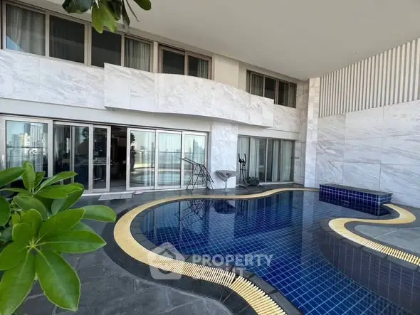Luxurious poolside view with modern architecture and cityscape backdrop.