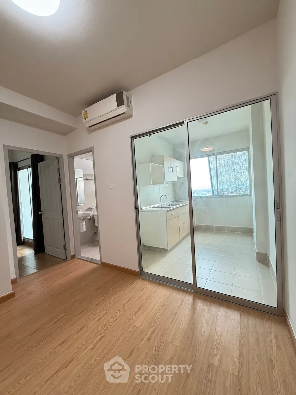 Spacious modern apartment with sleek kitchen and wooden flooring