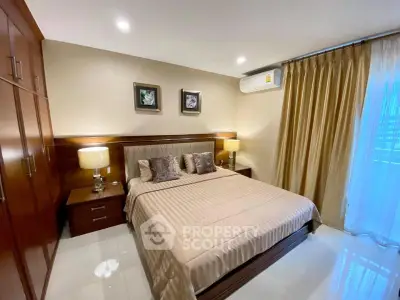 Elegant bedroom with cozy lighting and modern furnishings, featuring a large bed and stylish decor.