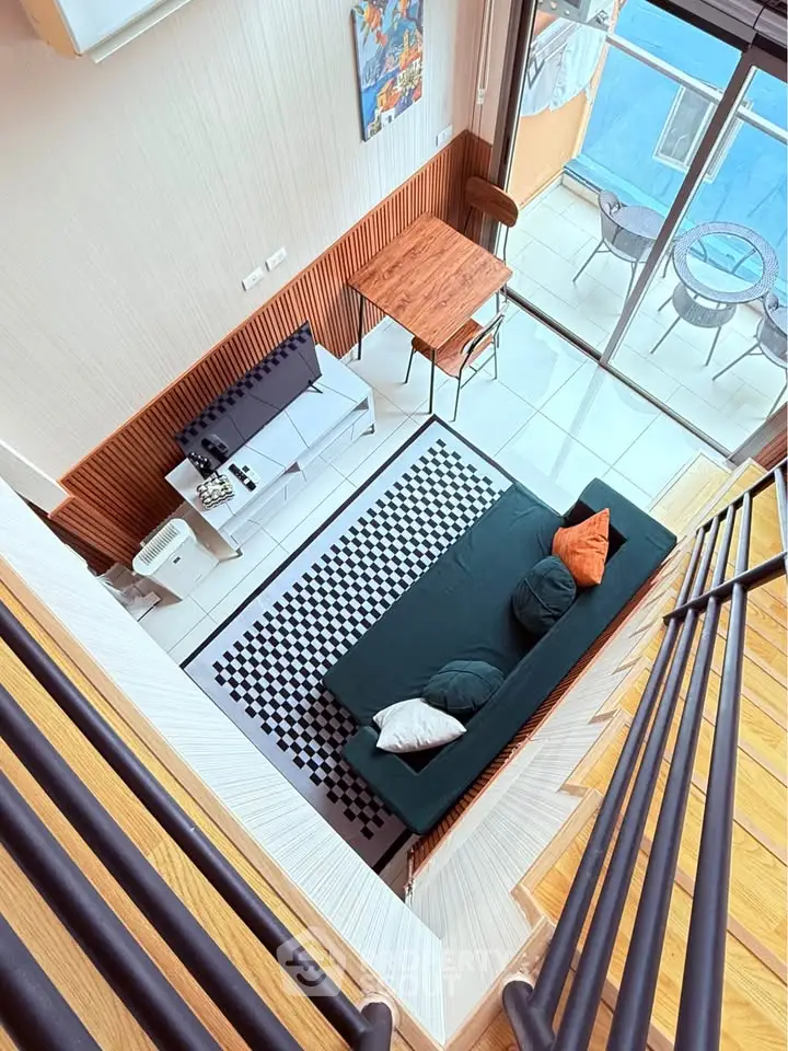 Modern loft-style living room with mezzanine view and balcony access