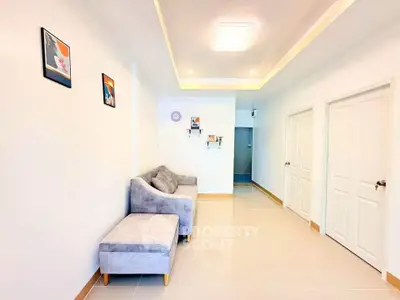 Bright and spacious living room with modern decor and cozy seating area.