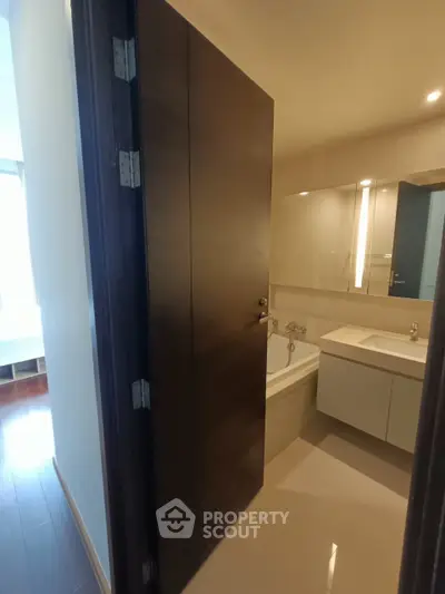 Modern bathroom with sleek design and bathtub in a contemporary apartment.