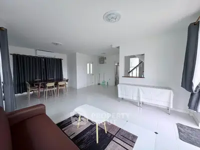 Spacious living room with modern furniture and large windows for natural light.