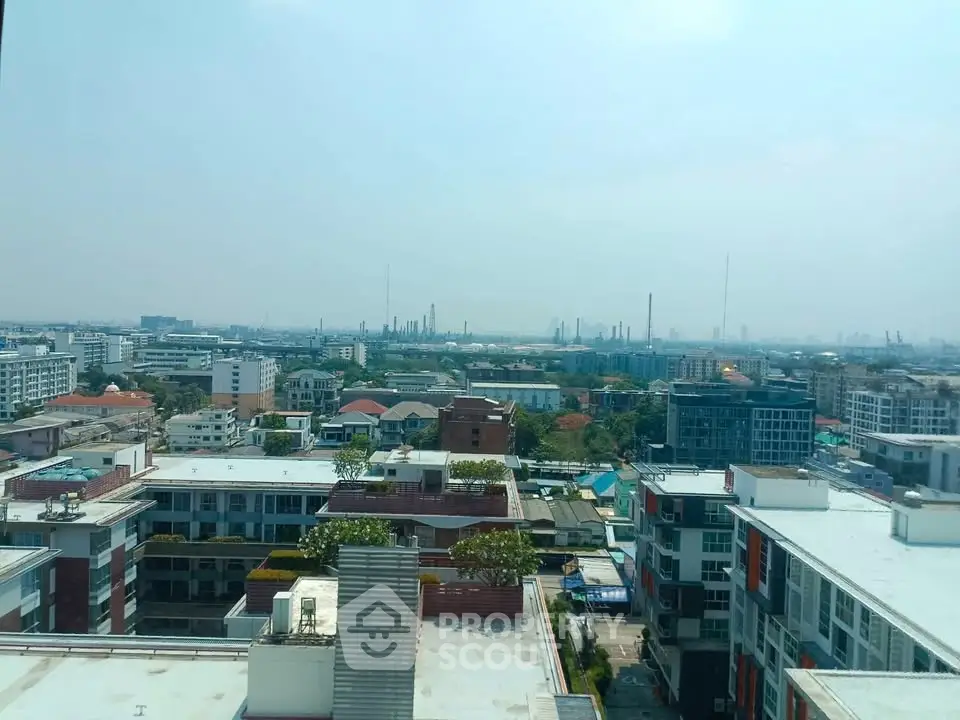 Stunning cityscape view from high-rise building showcasing urban skyline and residential areas.