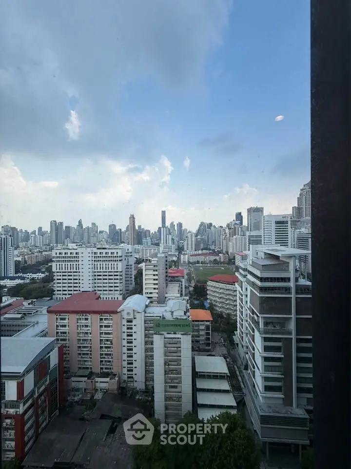 Stunning cityscape view from high-rise building window showcasing urban skyline.