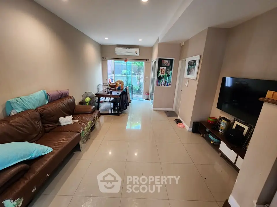 Spacious living room with modern decor and large windows for natural light.