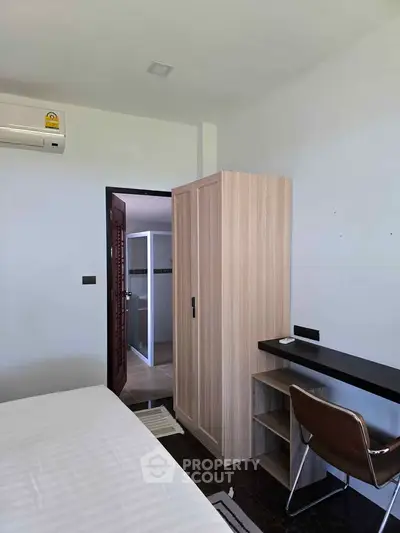 Modern bedroom with minimalist furniture and air conditioning in a stylish apartment.
