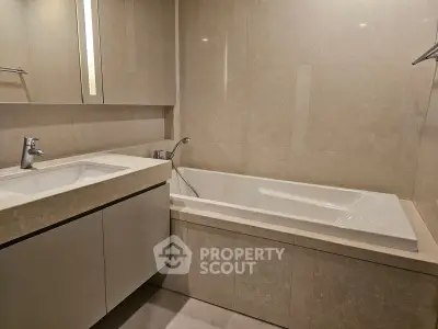Luxurious bathroom with elegant bathtub and modern sink in a stylish apartment.