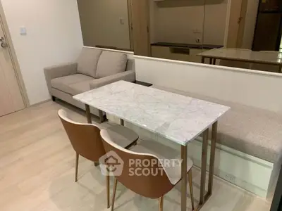 Modern living room with elegant marble dining table and cozy seating area